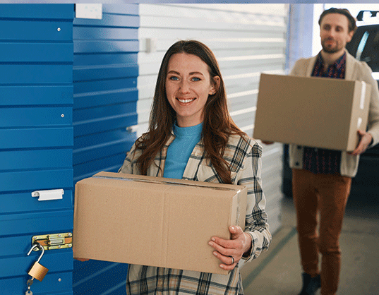 couple putting items into a storage unit