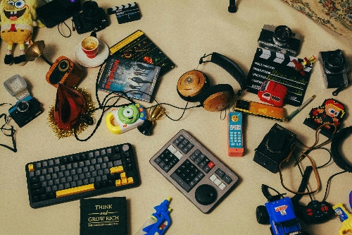 electronic clutter and junk including keyboards and headphones and cassette tapes.