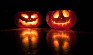 Two lit pumpkin lanterns in the dark Two lit pumpkin lanterns in the dark